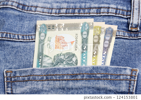 Eritrean Nakfa in the pocket of blue jeans 124153801