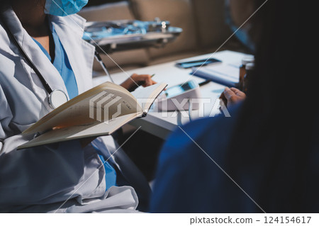 Doctor using sphygmomanometer with stethoscope checking blood pressure to a patient in the hospital. 124154617