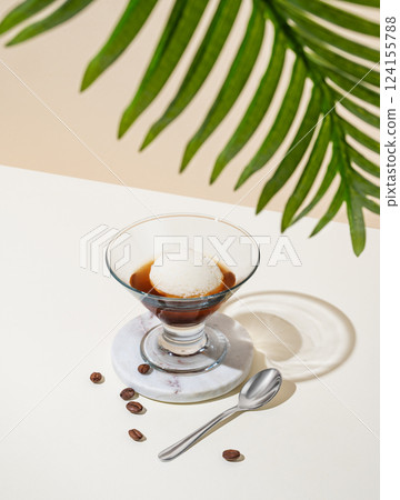Affogato coffee with a scoop of vanilla ice cream and espresso in a glass on a light background Affogato coffee with a scoop of vanilla ice cream and espresso in a glass on a light background 124155788