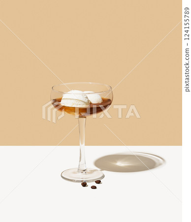 Affogato coffee with vanilla ice cream scoops and espresso in a tall glass on a beige background Affogato coffee with vanilla ice cream scoops and espresso in a tall glass on a beige background 124155789