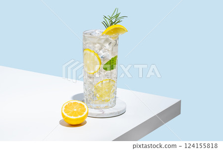 Lemonade with lemon, rosemary and ice in a glass on a white table. Summer citrus drink 124155818