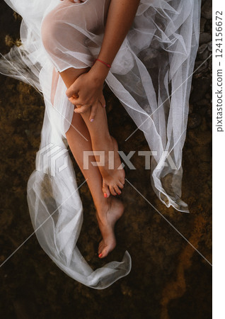 Peaceful Moment with Woman's Legs Wrapped in Tulle 124156672