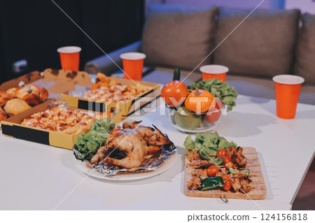 Happy young friends group having lunch at home. Asia family party eating pizza food and laughing enjoying meal while sitting at dining table together at house. Celebration holiday and togetherness. 124156818