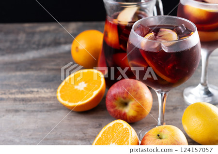 Refreshing Summer Citrus Fruit Sangria in crystal jar on wooden table 124157057
