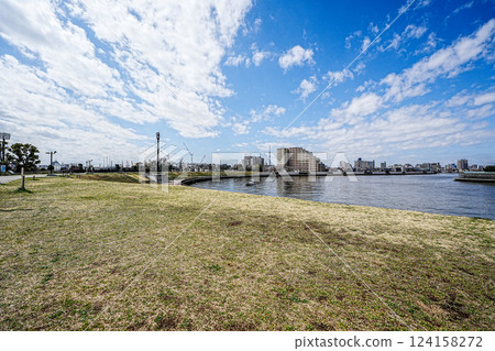 Spring Nakagawa River flowing through Katsushika Okuto, Tokyo and a town with a view of Skytree 124158272
