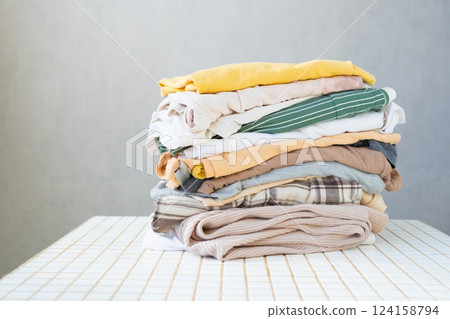 mockup, a stack of clean clothes on the table. dry cleaning. Housecleaning, housewife. mockup, a stack of clean clothes on the table. dry cleaning. Housecleaning, housewife. 124158794