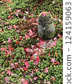 Jizo statue buried in fallen autumn leaves 124159063