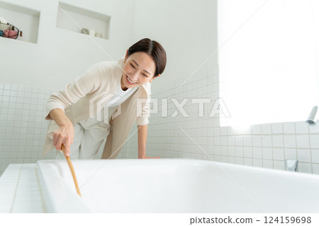 A woman cleaning a bath A woman cleaning a bath 124159698