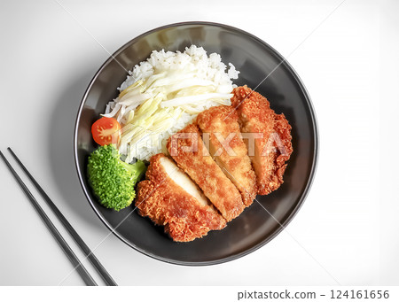 Image of a bowl of rice topped with pork cutlet Image of a bowl of rice topped with pork cutlet 124161656
