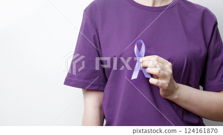 Purple ribbon held by a person in a purple shirt, symbol of support. Purple Epilepsy Awareness Day Purple ribbon held by a person in a purple shirt, symbol of support. Purple Epilepsy Awareness Day 124161870