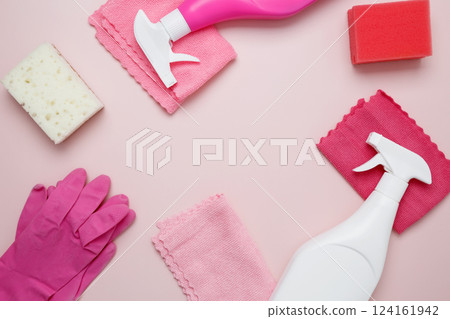 Pink cleaning supplies including rubber gloves, spray bottle, sponge, and microfiber cloths. Household cleaning and hygiene concept Pink cleaning supplies including rubber gloves, spray bottle, sponge, and microfiber cloths. Household cleaning and hygiene concept 124161942