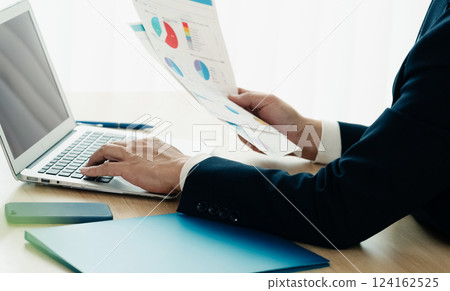 Businessman operating a personal computer 124162525