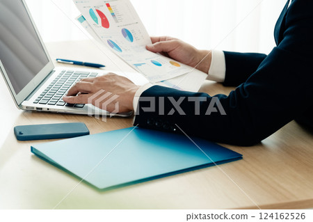 Businessman operating a personal computer Businessman operating a personal computer 124162526