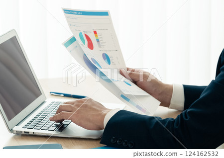 Businessman operating a personal computer 124162532
