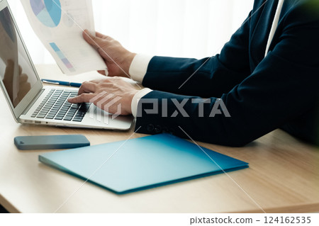 Businessman operating a personal computer 124162535
