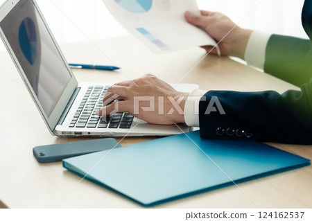 Businessman operating a personal computer 124162537