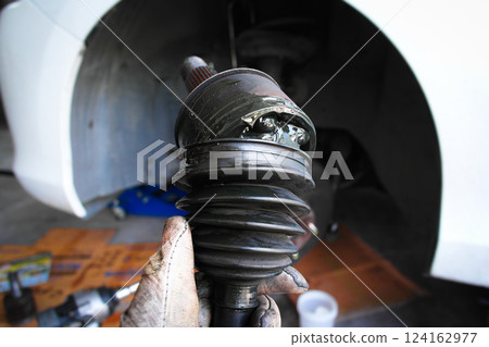 Close up of car CV joint or constant velocity joint damaged 124162977