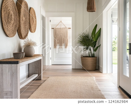 A modern coastal entryway with knot-patterned wall hangings and rope accents, creating a nostalgic, relaxed vibe for a welcoming space 124162984