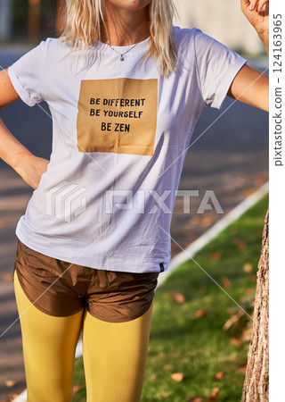 Inspirational Message on T-Shirt, Casual Style, Motivation, Blonde Woman, Outdoor, Inspirational Clothing Concept Inspirational Message on T-Shirt, Casual Style, Motivation, Blonde Woman, Outdoor, Inspirational Clothing Concept 124163965