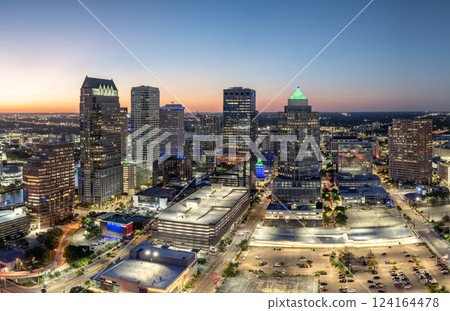 Downtown of Tampa in Florida, USA. Car traffic on city streets and brightly illuminated high skyscraper buildings. American travel destination. Downtown of Tampa in Florida, USA. Car traffic on city streets and brightly illuminated high skyscraper buildings. American travel destination. 124164478