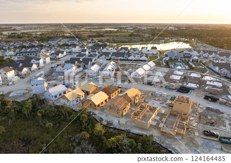 Development of residential housing in the USA. Wooden frames of new cheap American homes under construction 124164485