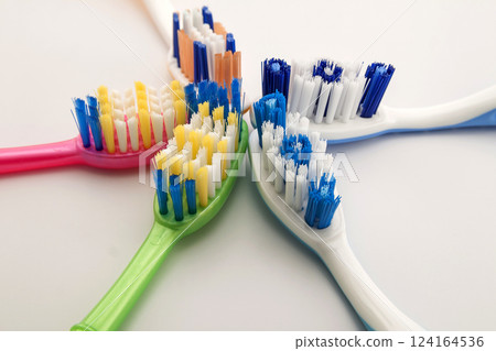 Colorful toothbrushes on white background with copy space. Macro with shallow dof. 124164536