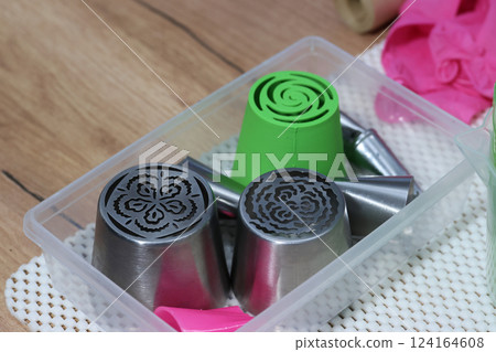 Metal and plastic pastry tips for making marshmallow flowers. Close-up. Metal and plastic pastry tips for making marshmallow flowers. Close-up. 124164608