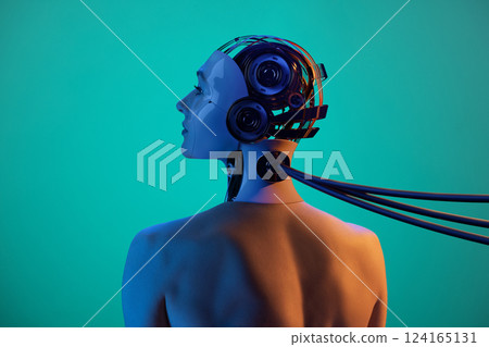 Handmade collage made of woman's portrait and 3D model of robot cyborg head connected with cables against green background in orange-blue lighting. Handmade collage made of woman's portrait and 3D model of robot cyborg head connected with cables against green background in orange-blue lighting. 124165131