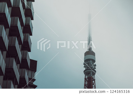Misty Tokyo Tower fades into dense fog while a vintage film effect 124165316