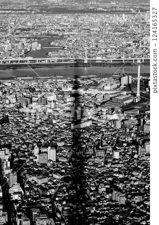 View of Tokyo, featuring the striking shadow of Tokyo Skytree cast over the dense urban landscape 124165327