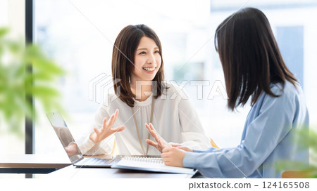 Two women/businesswomen having a meeting Two women/businesswomen having a meeting 124165508