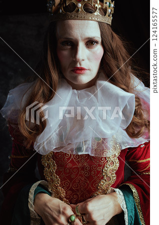 medieval queen in red dress with white collar and crown 124165577