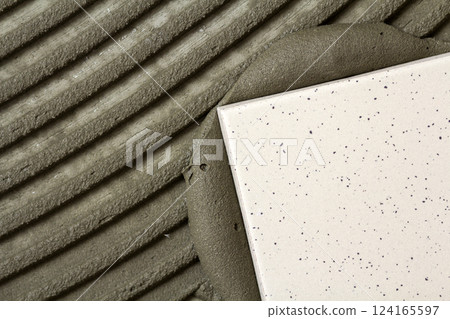 Ceramic tiles and tools for tiler. Floor tiles installation. Home improvement, renovation - ceramic tile floor adhesive Ceramic tiles and tools for tiler. Floor tiles installation. Home improvement, renovation - ceramic tile floor adhesive 124165597