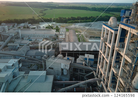 Cement plant with high factory structure and tower cranes at industrial production area. Manufacture, global industry and air pollution concept 124165598