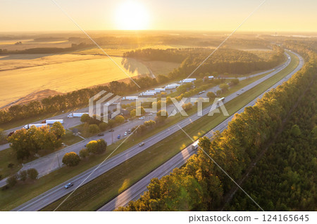 Big parking truck stop for tractor trailers rest area near busy American highway. Hauling cargo concept 124165645