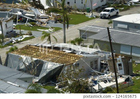 Badly damaged mobile homes after hurricane Ian in Florida residential area. Consequences of natural disaster Badly damaged mobile homes after hurricane Ian in Florida residential area. Consequences of natural disaster 124165675