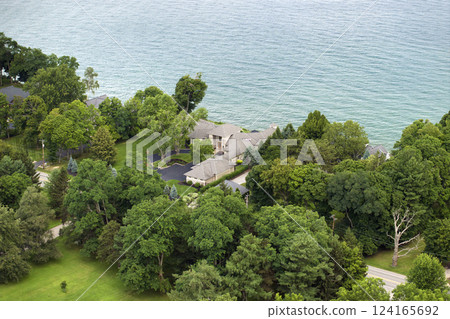 American dream homes on Ontario lakeshore as example of real estate development in US suburbs. View from above of waterfront residential houses in living area in Rochester, NY 124165692