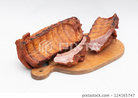 Delicious Smoked Pork Ribs Presented on a Wooden Cutting Board Delicious Smoked Pork Ribs Presented on a Wooden Cutting Board 124165747