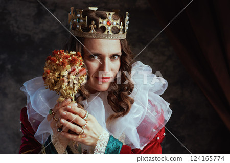 medieval queen in red dress with dried flower and white collar medieval queen in red dress with dried flower and white collar 124165774