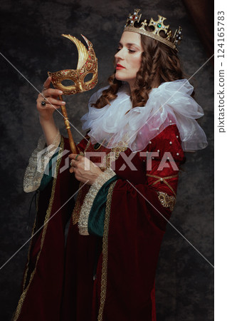 medieval queen in red dress with venetian mask 124165783