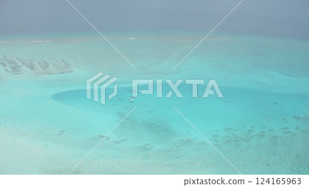 Boat sailing on crystal clear turquoise water in tropical paradise 124165963