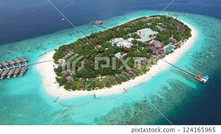 Tropical island resort in maldives offering luxurious overwater bungalows 124165965