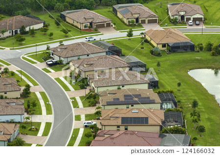 Aerial view of tightly located family houses in Florida closed suburban area. Real estate development in american suburbs 124166032