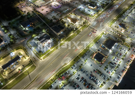 Aerial view of shopping plaza stores and American wide highway with many driving cars in North Port, Florida Aerial view of shopping plaza stores and American wide highway with many driving cars in North Port, Florida 124166059