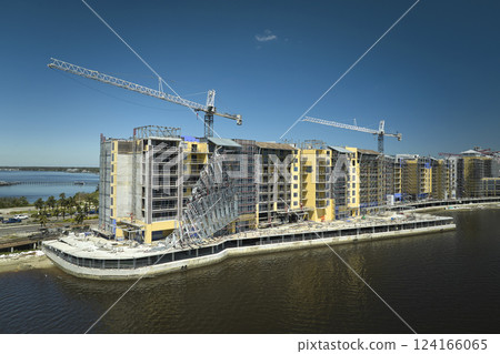Aerial view of ruined by hurricane Ian construction scaffolding on high apartment building site in Port Charlotte, USA Aerial view of ruined by hurricane Ian construction scaffolding on high apartment building site in Port Charlotte, USA 124166065