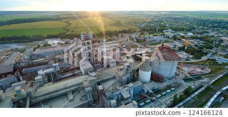Aerial view of cement factory tower with high concrete plant structure at industrial production area. Manufacturing and global industry concept. Aerial view of cement factory tower with high concrete plant structure at industrial production area. Manufacturing and global industry concept. 124166128