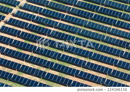 Aerial view of big sustainable electric power plant with many rows of solar photovoltaic panels for producing clean electrical energy. Renewable electricity with zero emission concept Aerial view of big sustainable electric power plant with many rows of solar photovoltaic panels for producing clean electrical energy. Renewable electricity with zero emission concept 124166138
