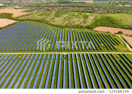 Aerial view of big sustainable electric power plant with many rows of solar photovoltaic panels for producing clean ecological electrical energy. Renewable electricity with zero emission concept. Aerial view of big sustainable electric power plant with many rows of solar photovoltaic panels for producing clean ecological electrical energy. Renewable electricity with zero emission concept. 124166144