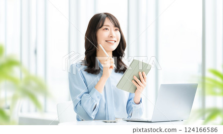 Woman doing desk work / business woman Woman doing desk work / business woman 124166586