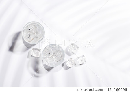 Crystal-clear glasses filled with chilled water and ice cubes 124166996